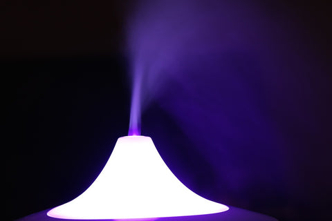 Diffuser with violet lighting that releases a mist.